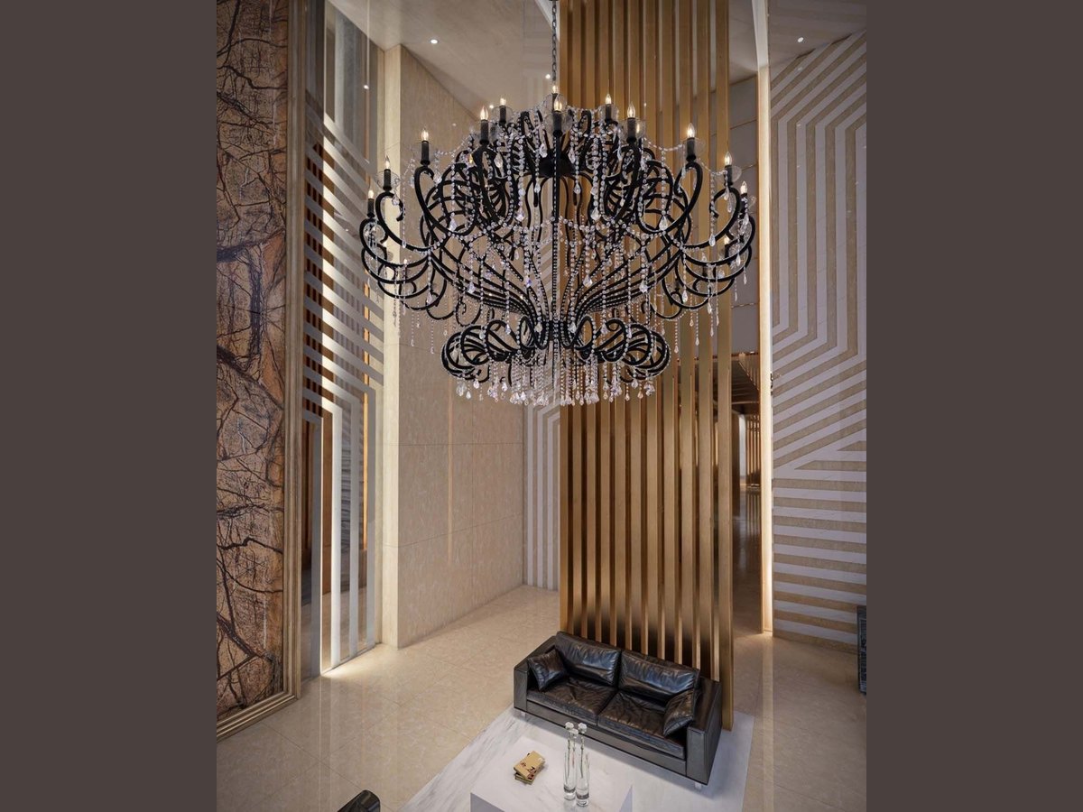 Sculptural black scroll chandelier in a hotel lobby