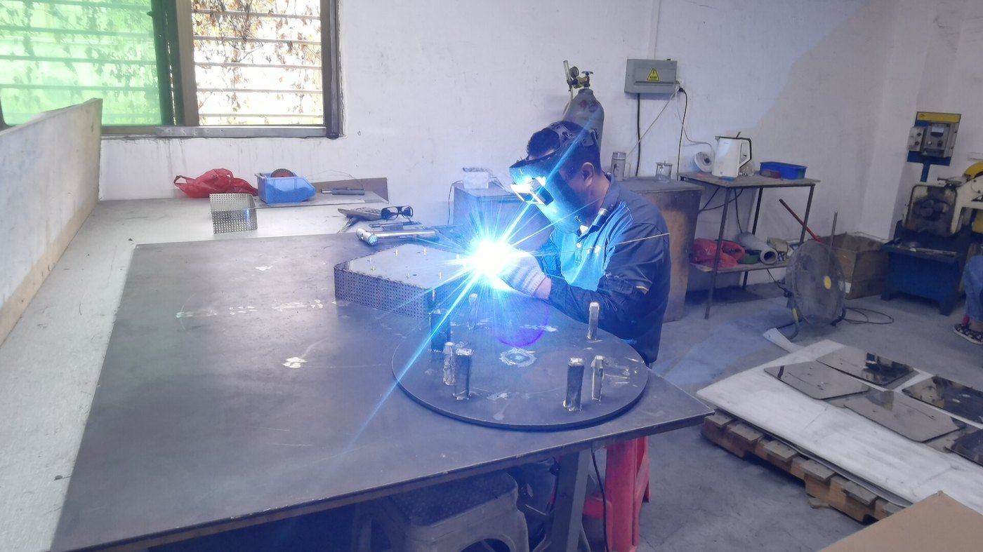 TIG welding arc close-up on a chandelier body